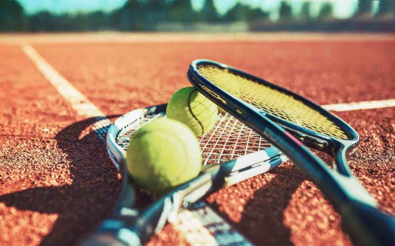 tennis ball with racket on the tennis court. sport, recreation concept